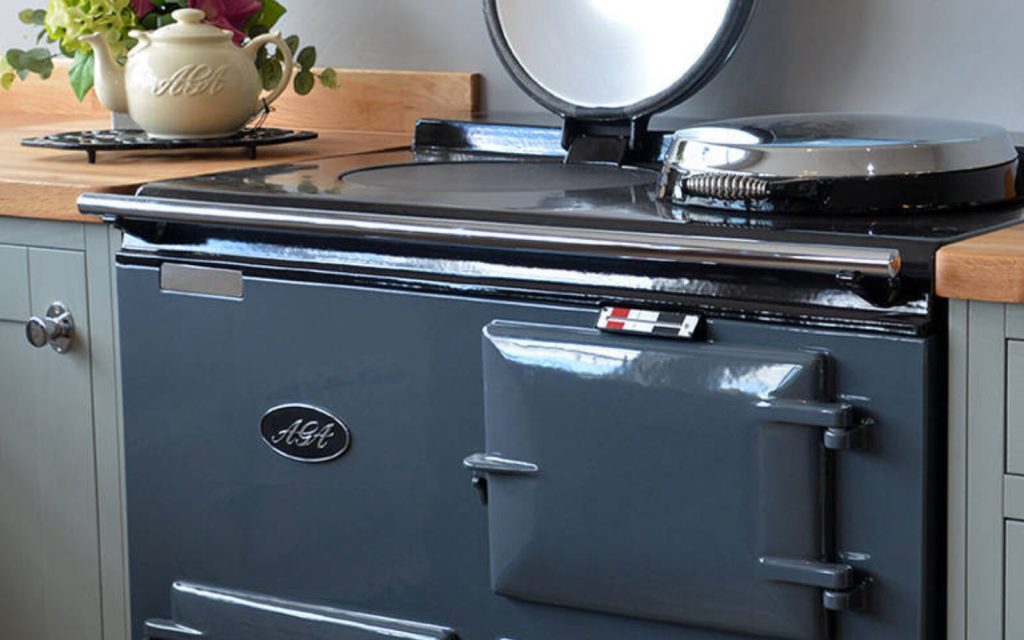“Professional AGA cooker cleaning in Harrogate by Yorkshire Oven Clean — restored shine on a classic blue cast‑iron AGA in a modern Yorkshire kitchen.”