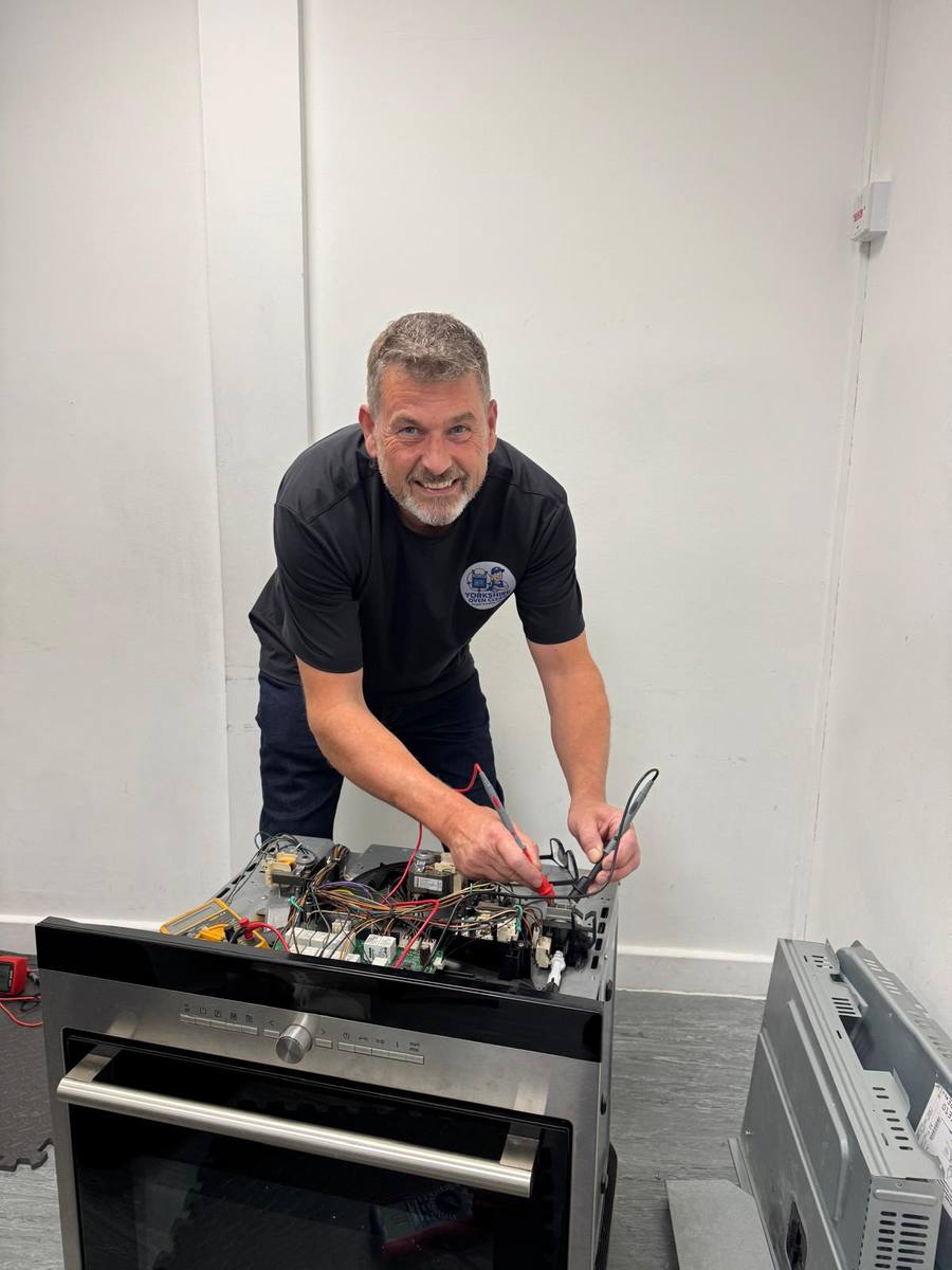 Adam Henderson of Yorkshire Oven Clean repairing an electric oven