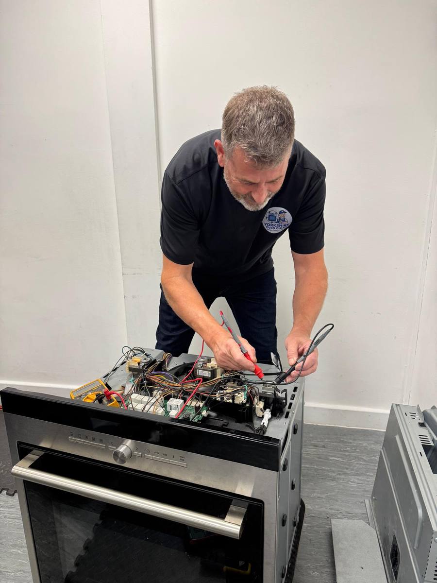 Adam from Yorkshire Oven Clean testing the wiring on a built-in electric oven