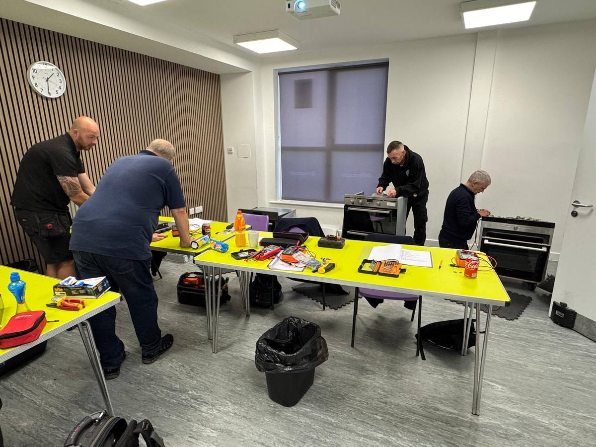 Oven repair course classroom with trainees working at benches and ovens